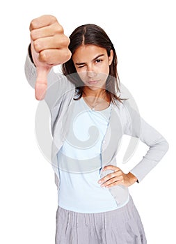 Young woman, hand and thumbs down with wink in disappointment, fail or wrong against a white studio background. Portrait