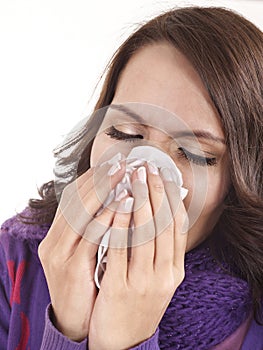 Young woman with handkerchief having cold.