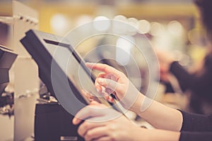 Young woman hands counting, entering discount, sale to a touchscreen cash register, POS, finance concept