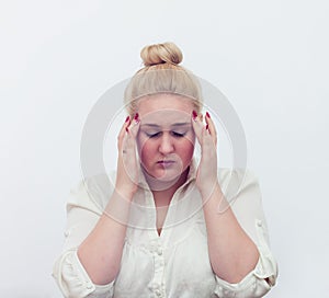 Young woman hands on head headache on white