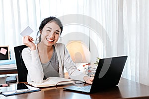 Young woman hands holding credit card and using laptop for online shopping. Credit card buy or paymaent conceptl