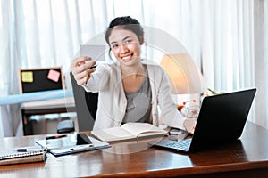 Young woman hands holding credit card and using laptop for online shopping. Credit card buy or paymaent conceptl