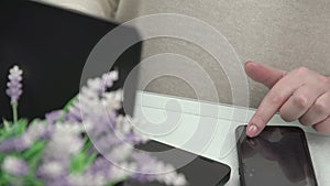 Young woman hands with manicure type on black smartphone