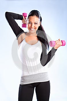 Young woman hang up hands weights