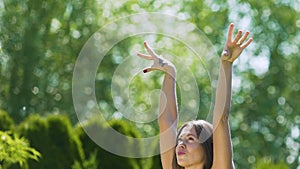 Young woman happiness, lady raises hands up feeling oneness with nature, slow