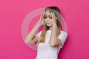 Young Woman Has A Headache And Is Holding Her Head In Her Hands