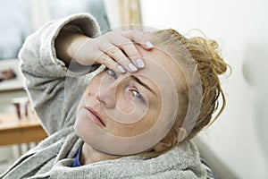 Young woman has headache and stay at home