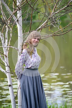 The young woman has leaned against the blossoming birch of useful Himalaya Betula utilis D.Don