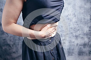 A young woman has stomach pain