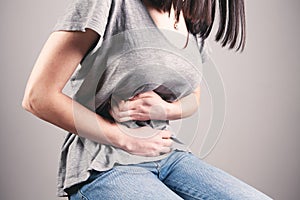 A young woman has stomach pain