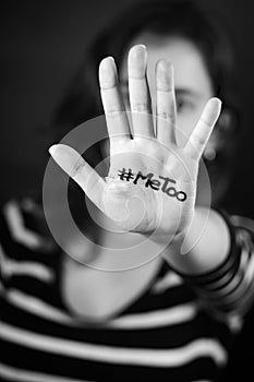 Young woman with the hashtag MeToo written on her hand photo