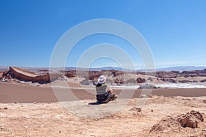 Young woman in hat admiring american landscape of untouched nature with unique landscape with copy space