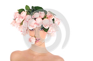 Young woman in a hat of roses isolated on white