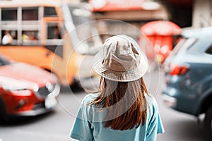 Young Woman with hat traveling in Bangkok, Asian traveler visiting at Yaowarat road or Chinatown of Bangkok, landmark and popular