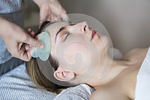 Young woman have face treatment at beauty clinic photo
