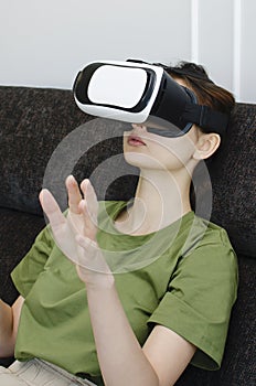 Young woman have fun in virtual reality headset or 3d glasses playing video game, gaming and technology concept.Vertical