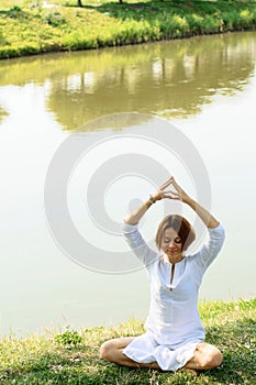 Young woman have morning meditation at the picturesque place photo