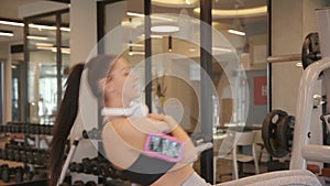 Young woman have a training at sit up bench in the gym