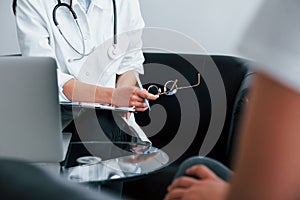 Young woman have a visit with female doctor in modern clinic