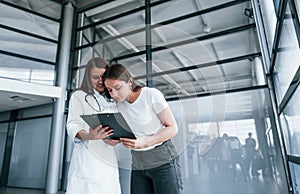 Young woman have a visit with female doctor in modern clinic