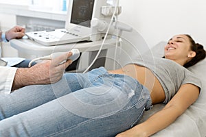 Young woman having 4D ultrasound scan. Ultrasound imaging,examination of the abdomen