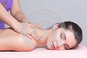 Young woman having back massage close up