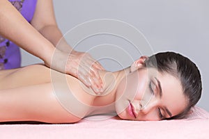 Young woman having back massage close up