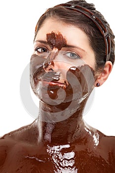 Young woman having a chocolate face mask