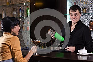 Young woman having a drink at the bar