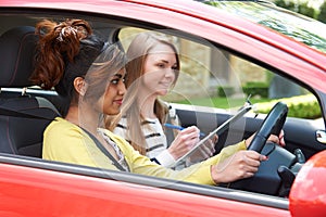 Young Woman Having Driving Lesson With Female Instructor