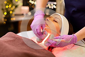 Young woman having face microdermabrasion at spa