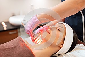 Young woman having face microdermabrasion at spa