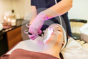 Young woman having face microdermabrasion at spa