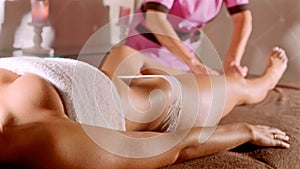 Young woman having feet massage in beauty spa salon.