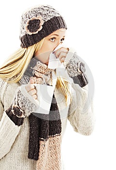 Young woman having flu and blowing her nose at handkerchief