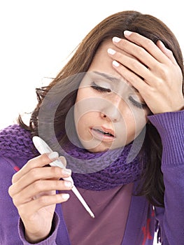 Young woman having flue taking thermometer.