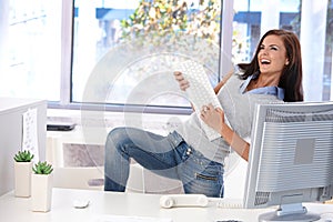 Young woman having fun in bright office