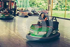 Young woman having fun in electric bumper car