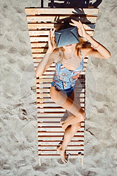 Young woman having fun with VR glasses on beach