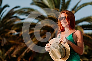 Young woman in the wind by the palm trees