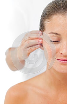 Young woman having a head massage in a spa