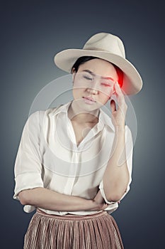 Young woman having headache in dark background with clipping path