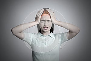 Young woman having headache on light grey background