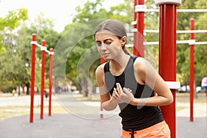 Young woman having heart attack on ground