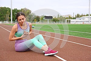 Young woman having heart attack while running