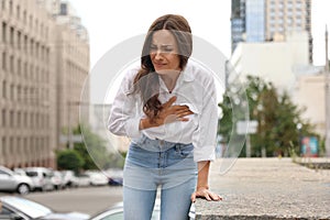 Young woman having heart attack on street