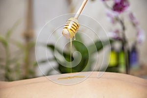 Young woman having a honey back massage