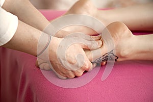 Young woman having massage in spa salon studio.