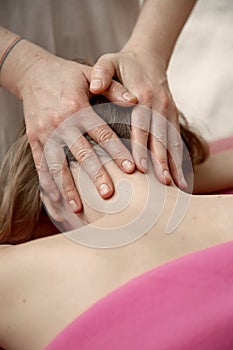 Young woman having massage in spa salon studio.