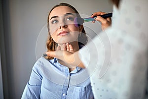 Young woman having natural make up applied